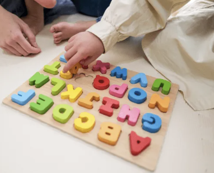 Student matching alphabet letters to spaces