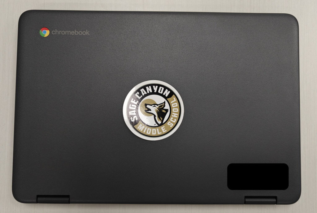 picture of a Chromebook with a Sage Canyon sticker on it