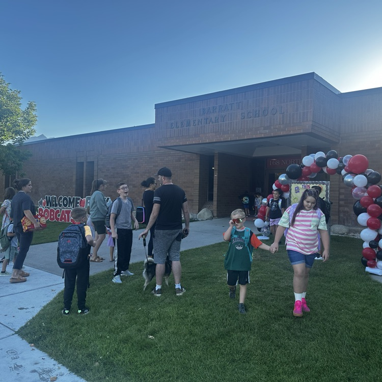 adults and students waiting for school to start