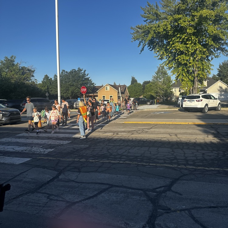 students crossing the parking lot
