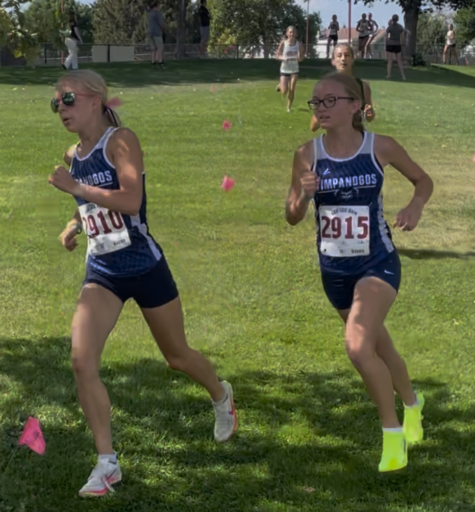 Female  runners on a grass field.