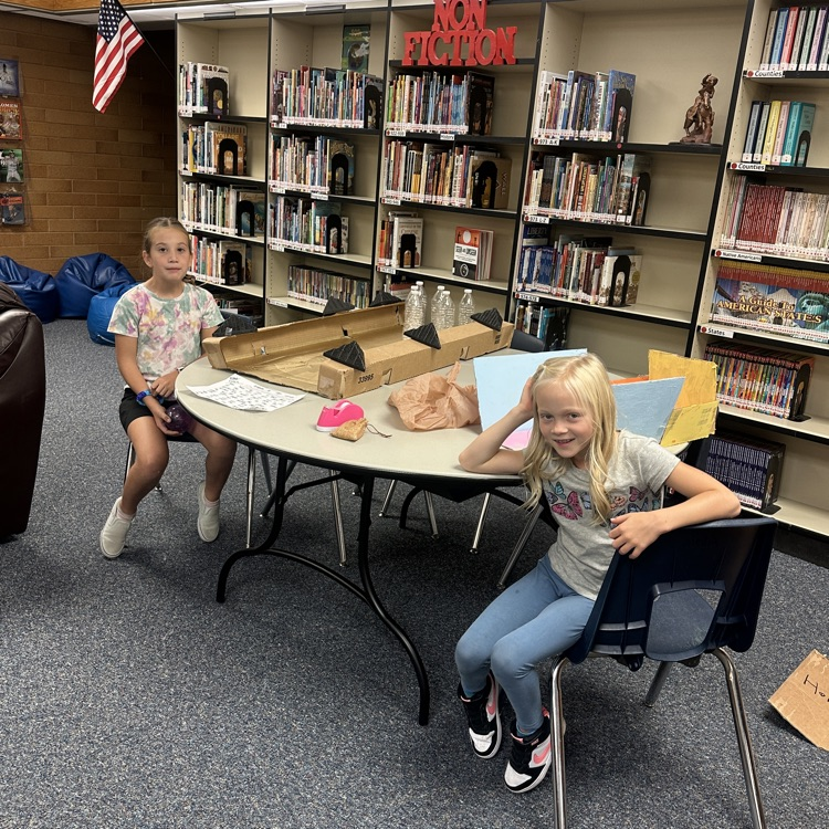 kids at play on homemade cardboard arcade game