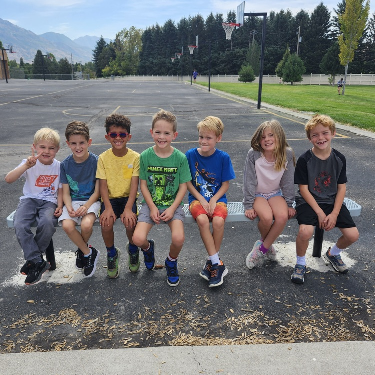 students sitting on a bench at the Highland playground