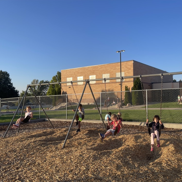 kindergarten students on the swings