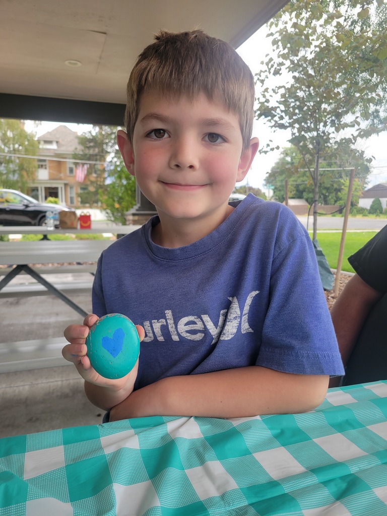 Student painting a kindness rock to give away.