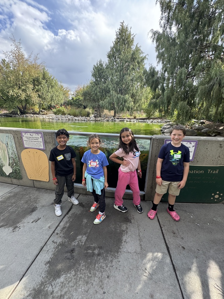 students in front of water