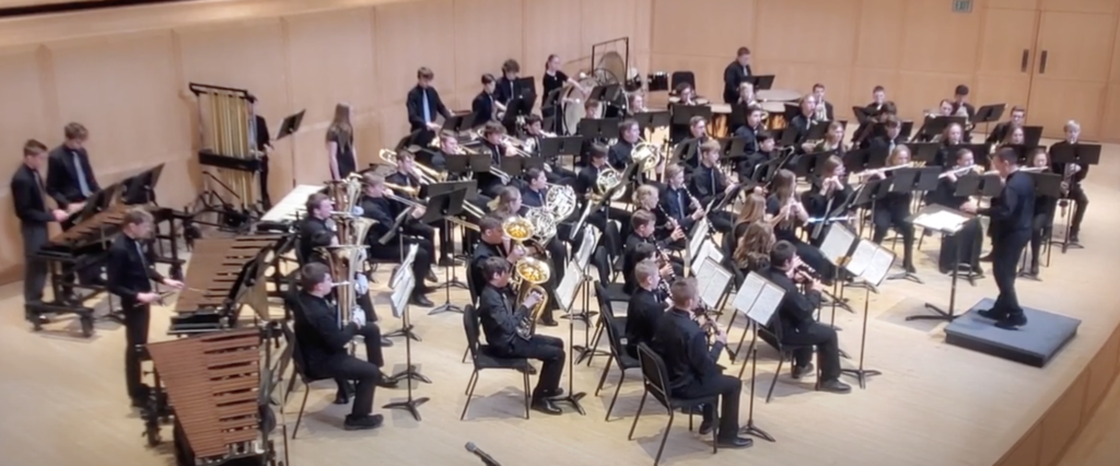 Wind Symphony, Dressed in Black, Sitting on Stage, Preforming Music