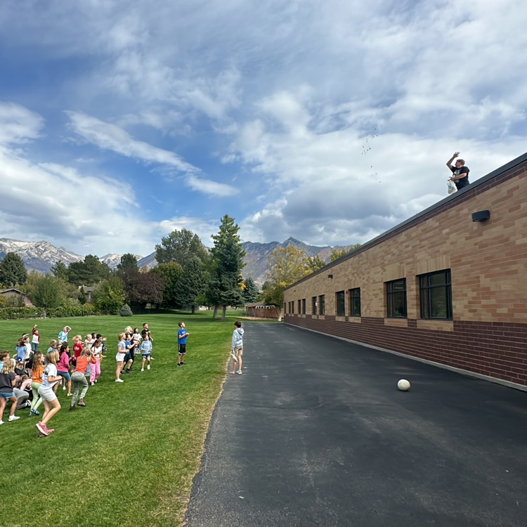 kids catching candy thrown from the roof  