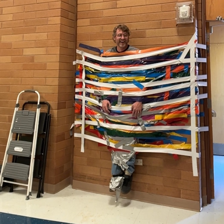 Mr. Killpack taped to a wall