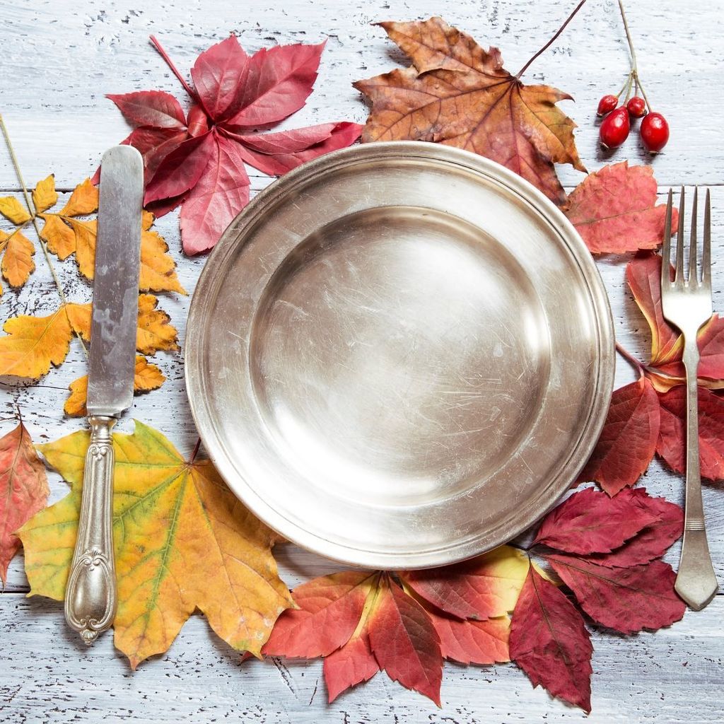 dinner plate with fall leaves behind it