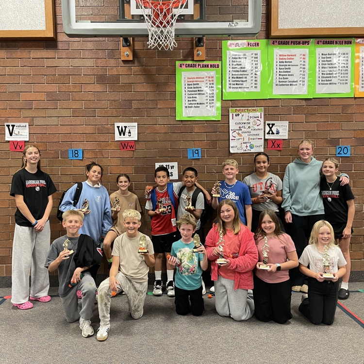 group sitting and standing by a basketball hoop