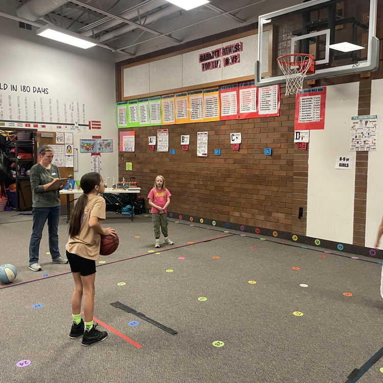 girl shooting a basketball