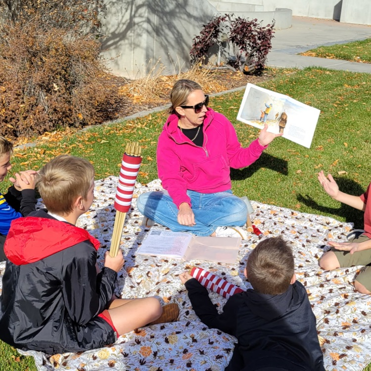students listening to the story about the veterans wall