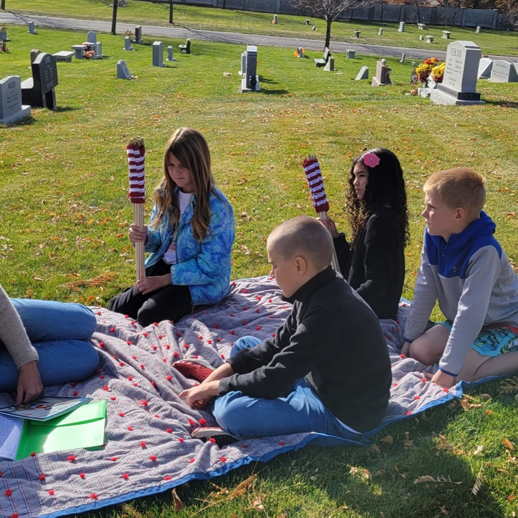 tudents listening to the story about the veterans wall