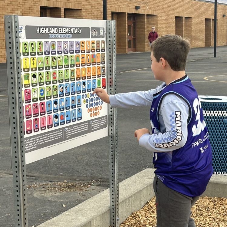 students interacting with the communication board