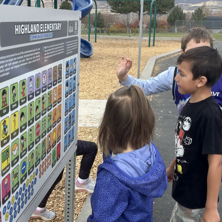students interacting with the communication board