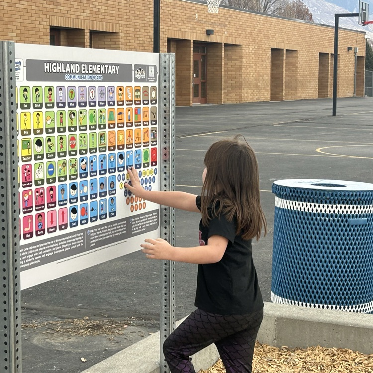 students interacting with the communication board