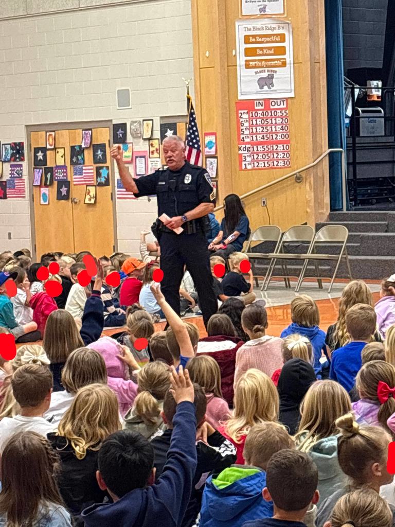 police officer talking to students