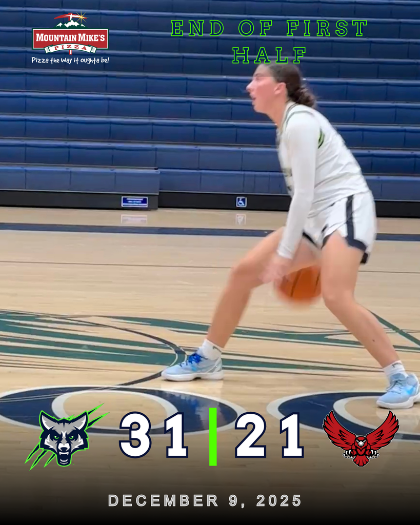 A girls basketball player in a white and navy Timpanogos uniform dribbles the ball near midcourt inside an empty gym with blue bleachers. The graphic reads “End of First Half” with the score 31–21, Timpanogos leading South Summit, dated December 9, 2025. Mountain Mike’s Pizza logo appears in the corner.