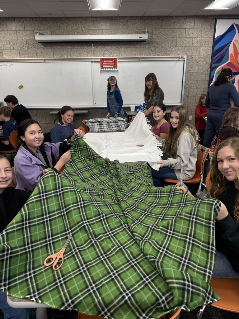 Students making a blanket. 