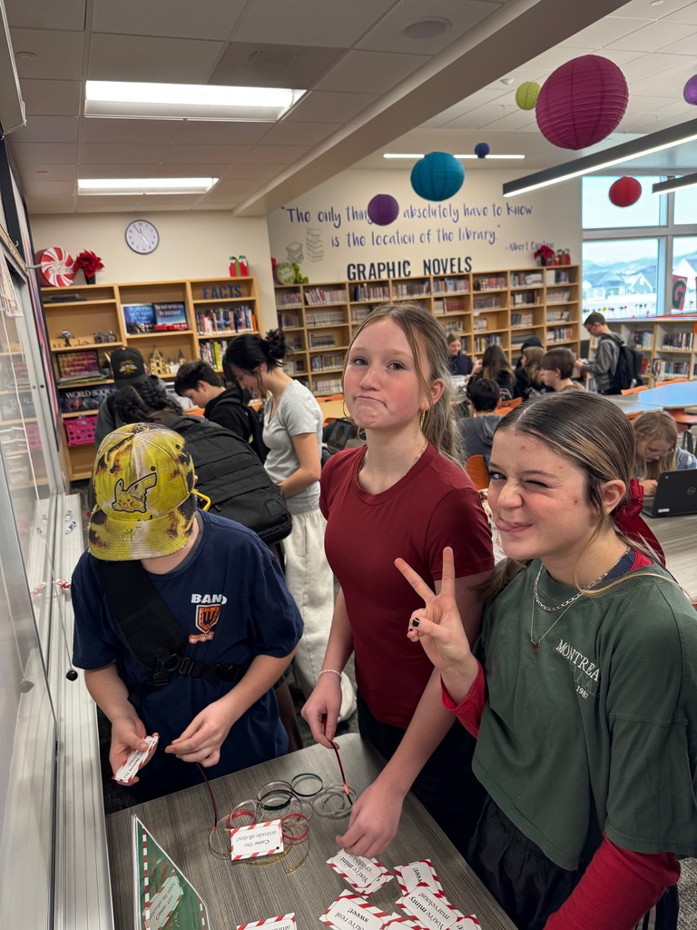 3 students cutting ribbons. 