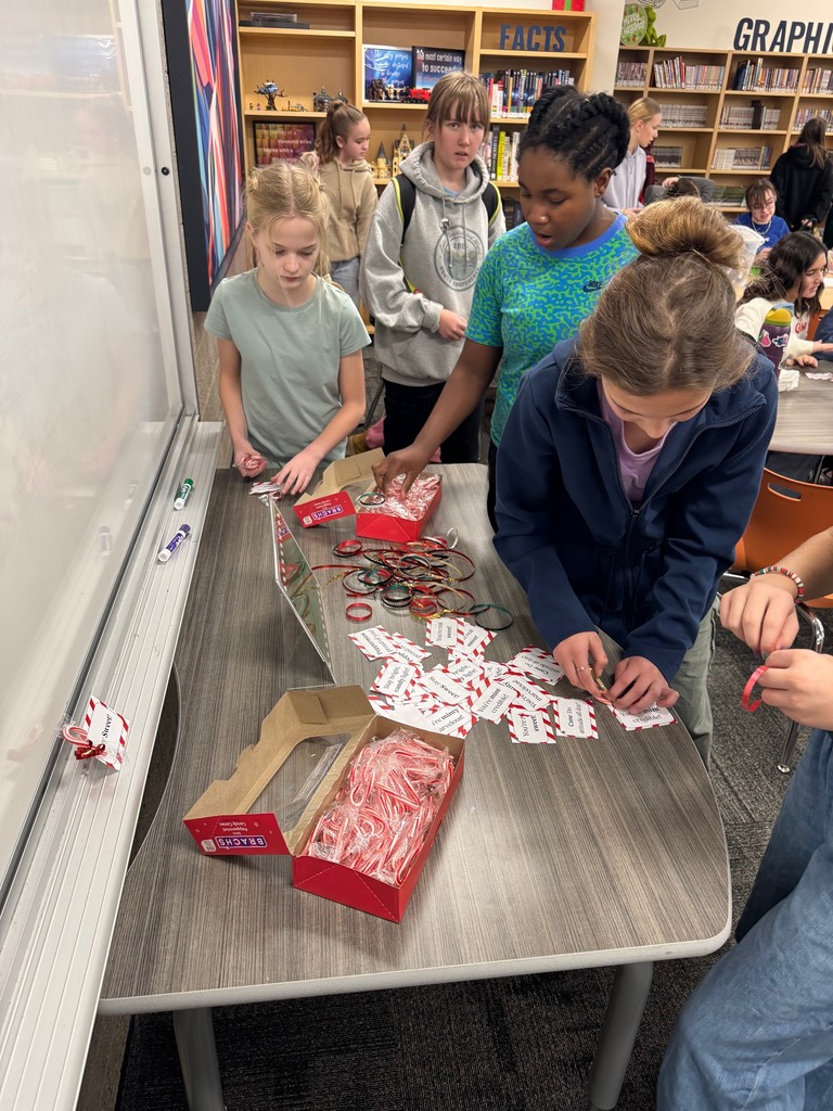 Several students focused on making assembling candy canes with tags and ribbons