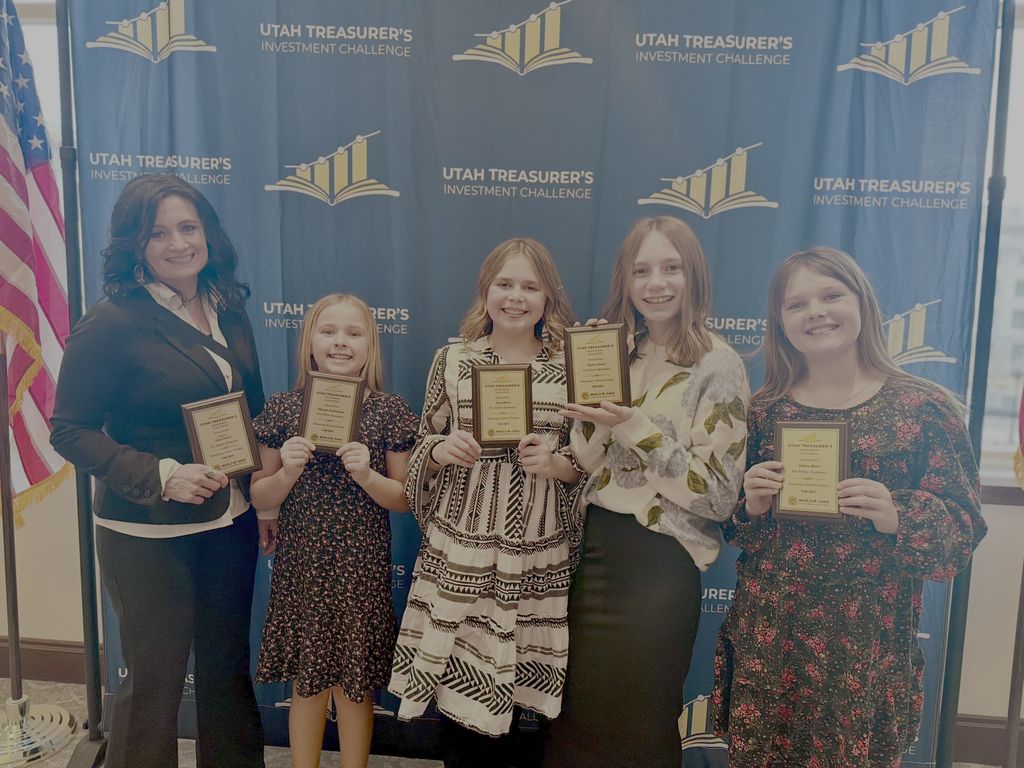 picture of girls holding award plaques