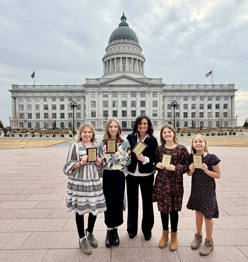 picture of girls holding award plaques