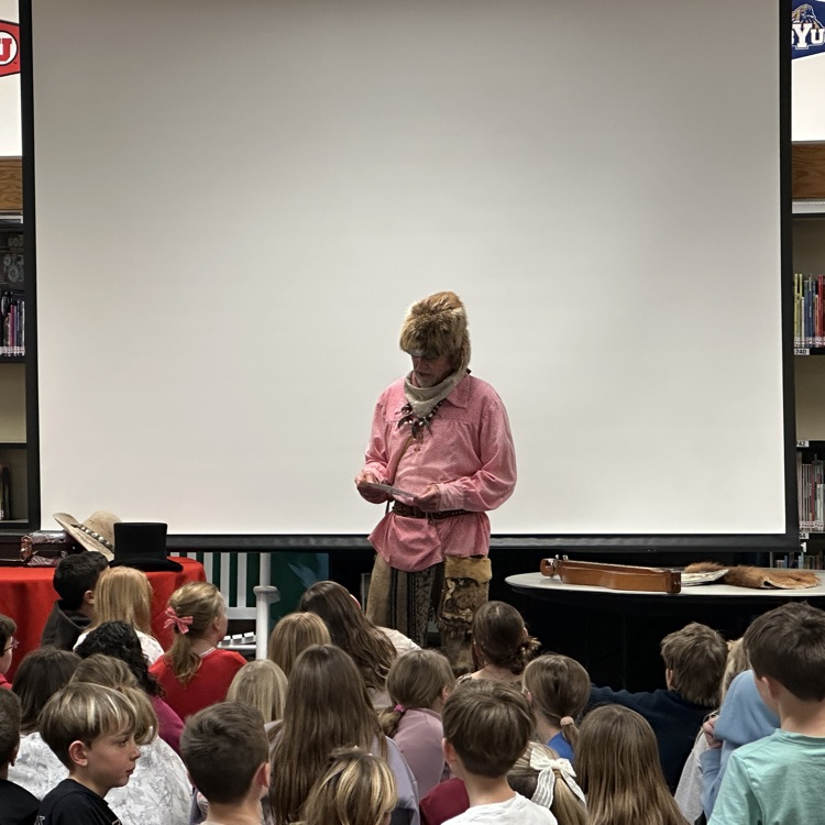 mountain man giving a presentation to 4th graders 