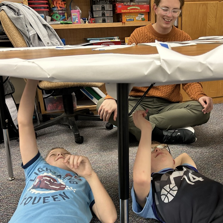 students drawing under the table like Michelangelo 