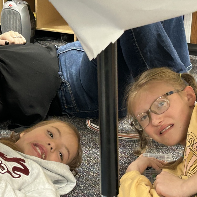students drawing under the table like Michelangelo