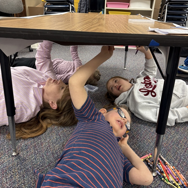 students drawing under the table like Michelangelo