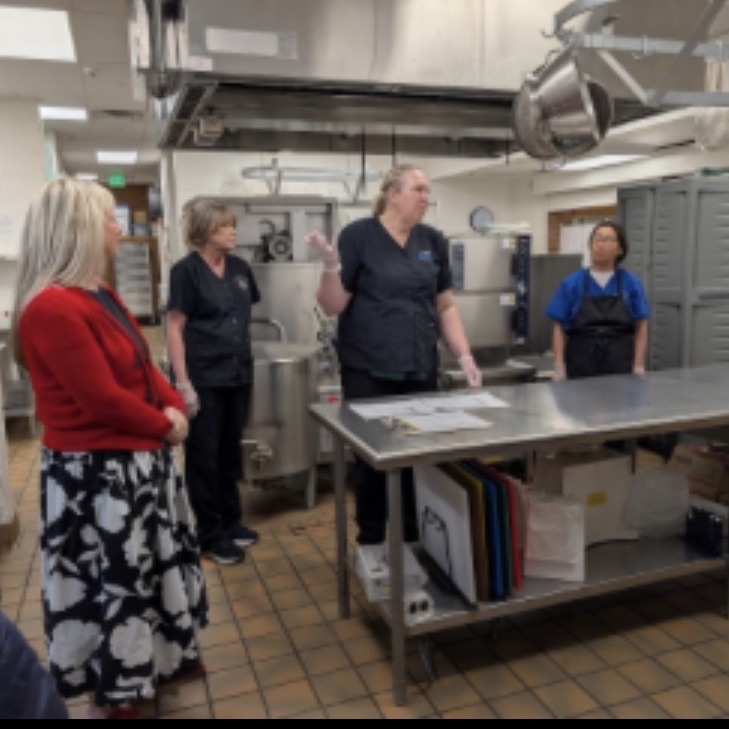 people standing in a school kitchen 