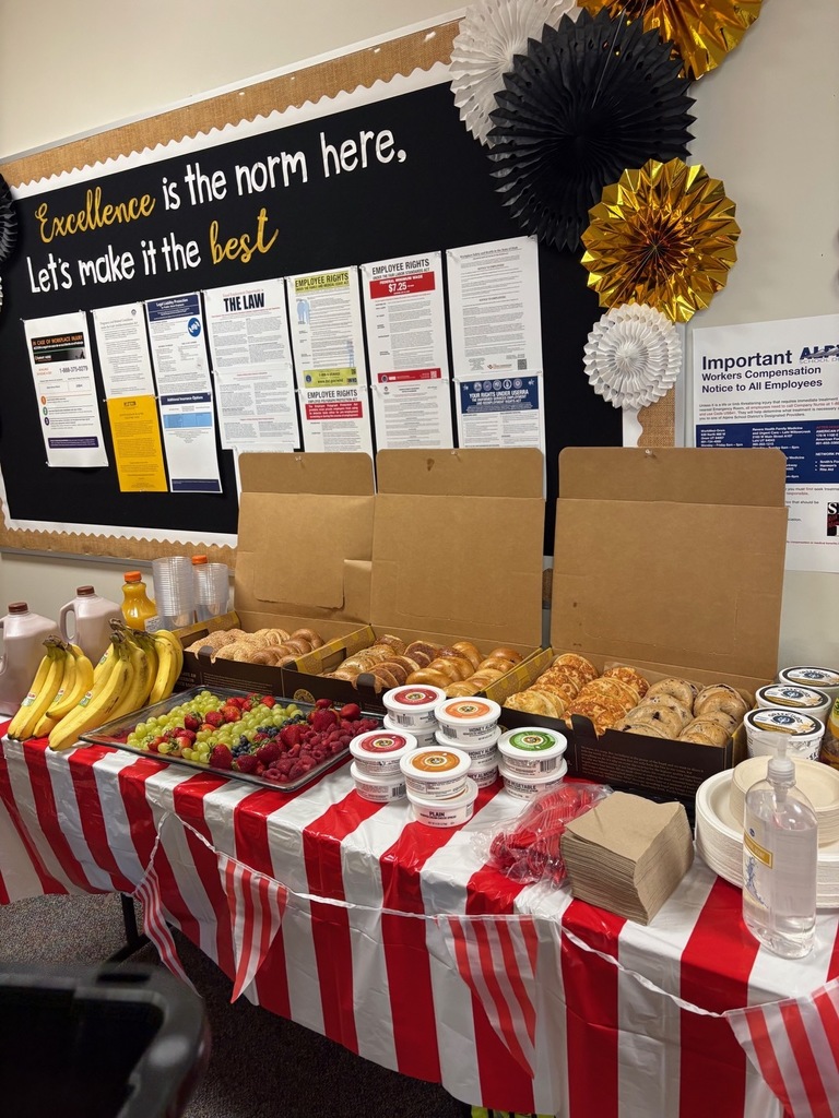 Table with bagels and fruit on it. 