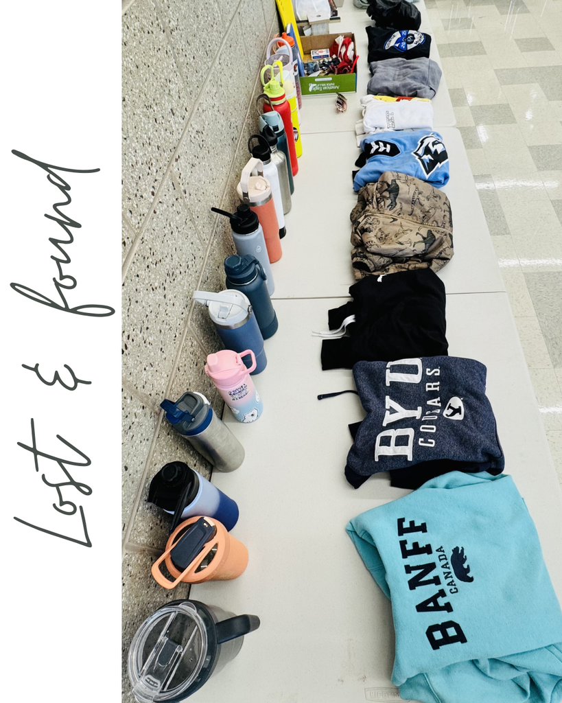 "Lost and found" photo includes various water bottles and items of clothing on a table.
