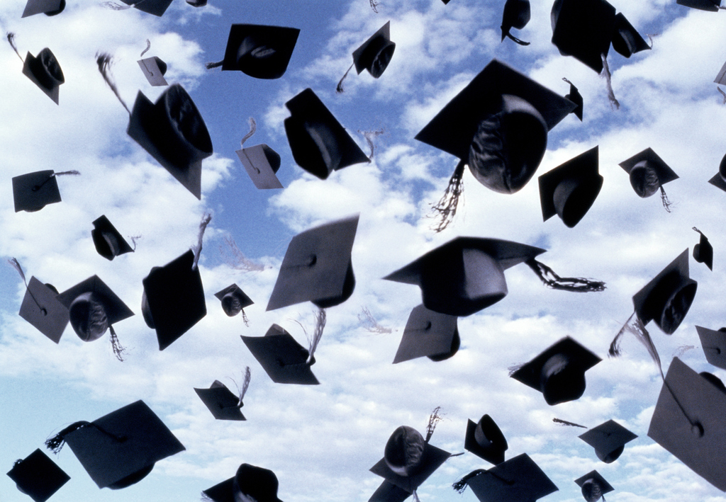 Graduation caps floating in the sky