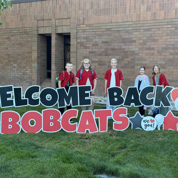 students standing in front of school