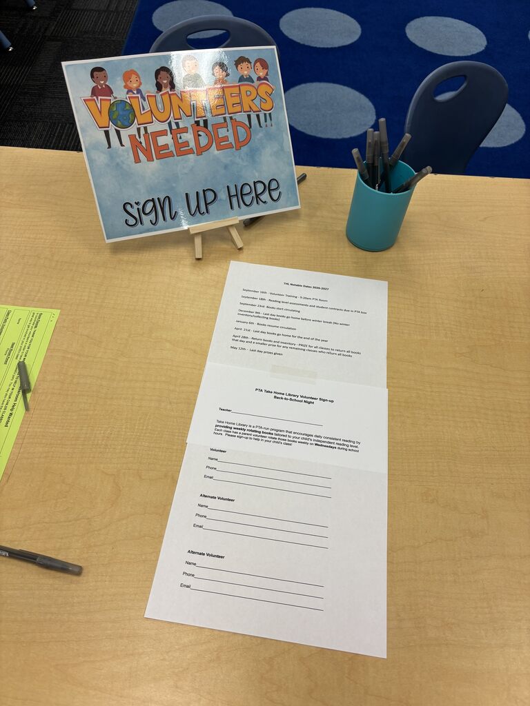 picture of a desk with papers and pens