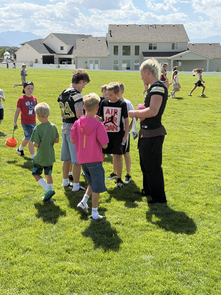 football player talking to kids