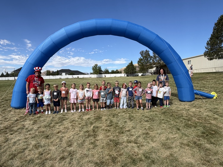 students standing under a running arch