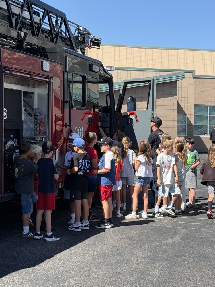 students in front of a fire truck