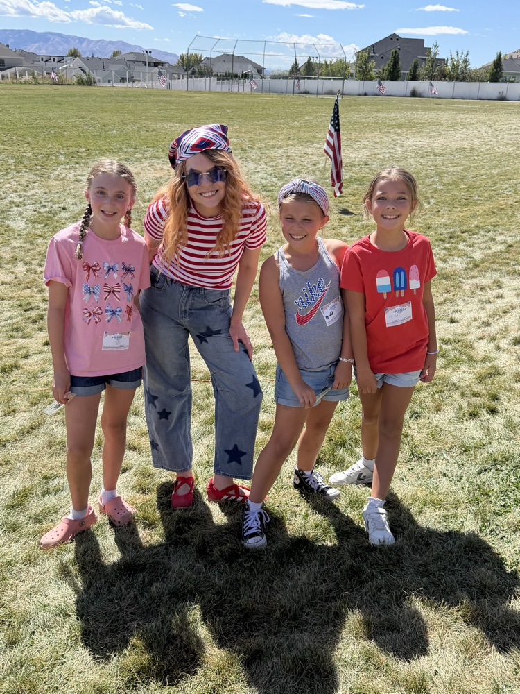 teacher and students in red, white, and blue