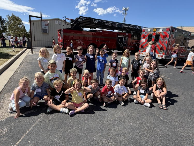 group in front of a fire truck