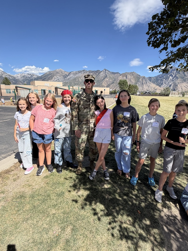 students around a soldier