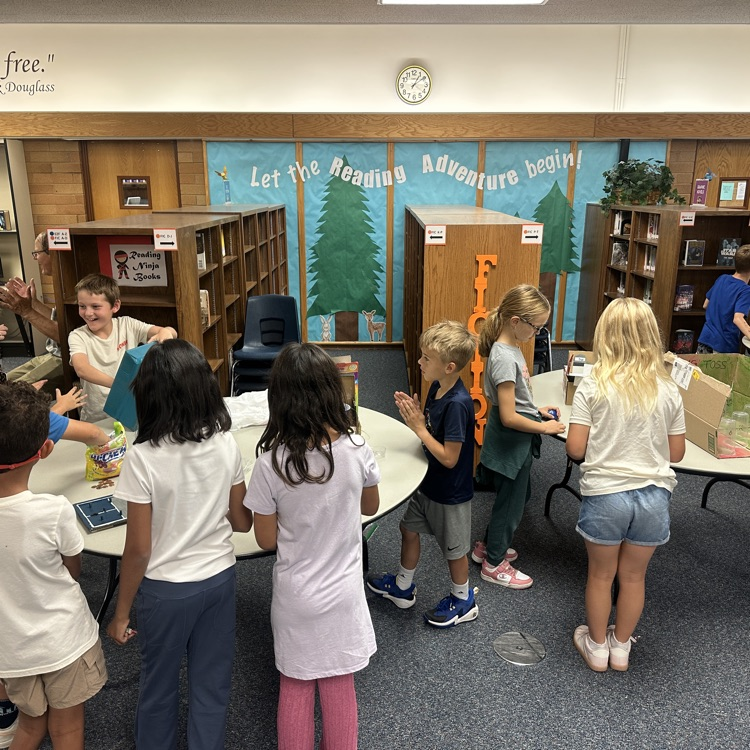 students playing cardboard arcade games  