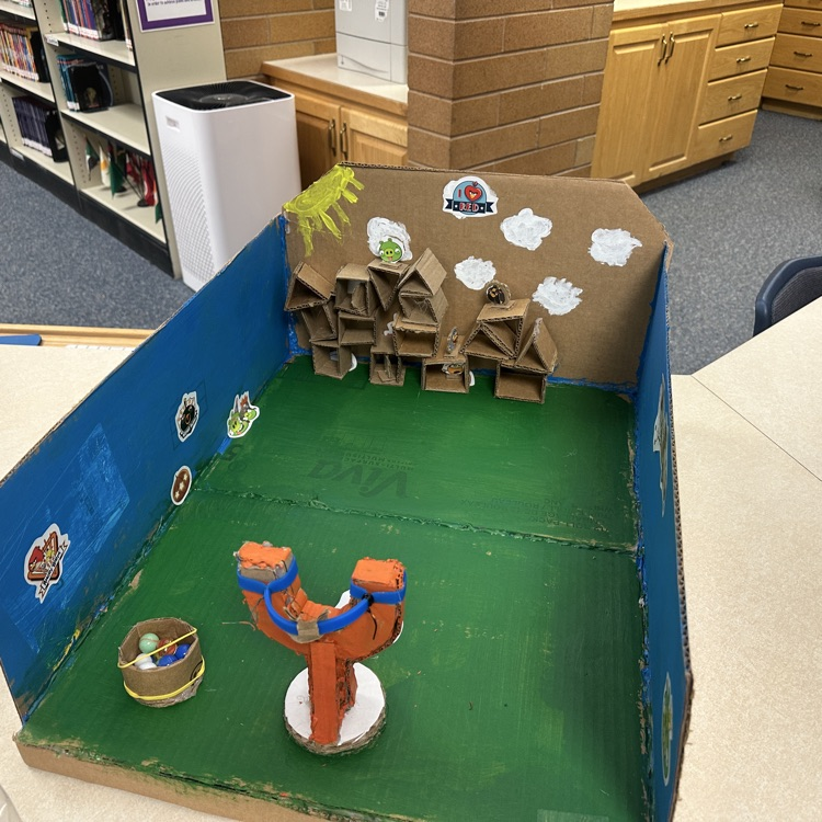 students playing cardboard arcade games.