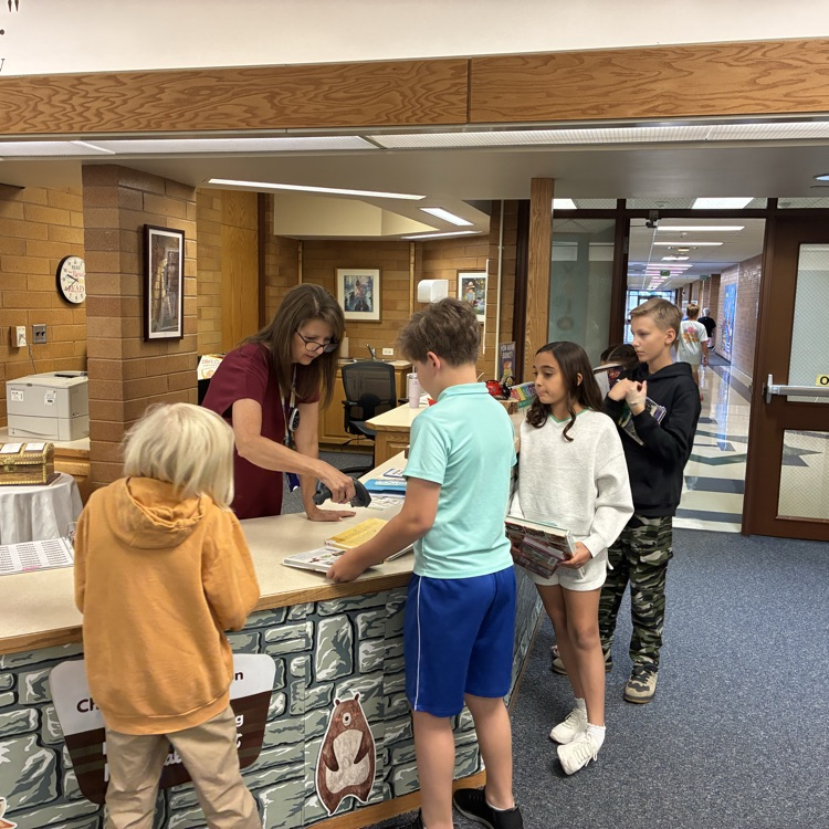  students checking out books 