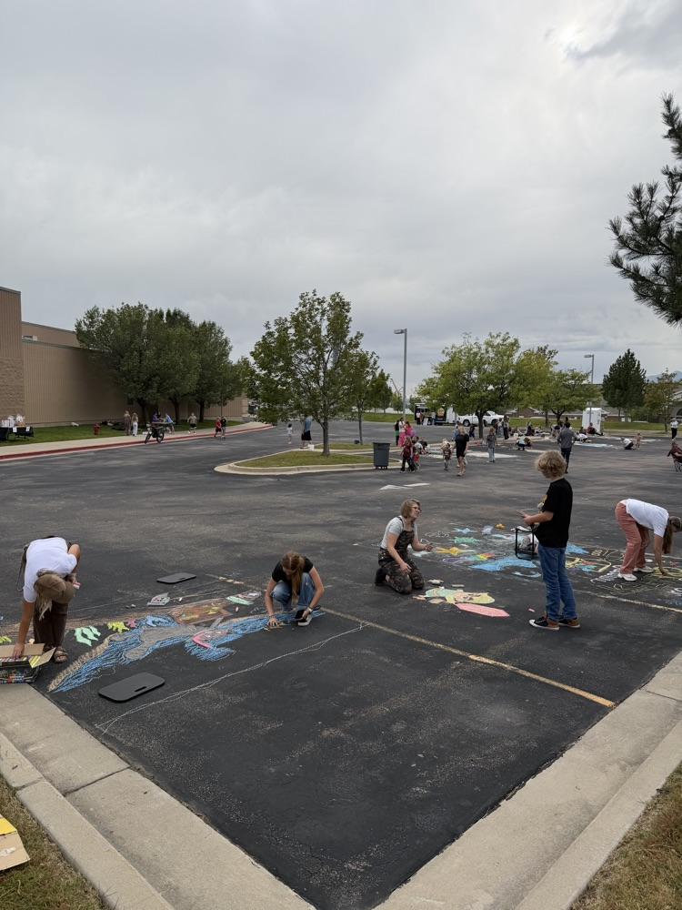 groups working on chalk night murals