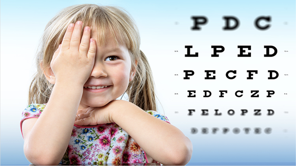Young child covering one eye with hand
