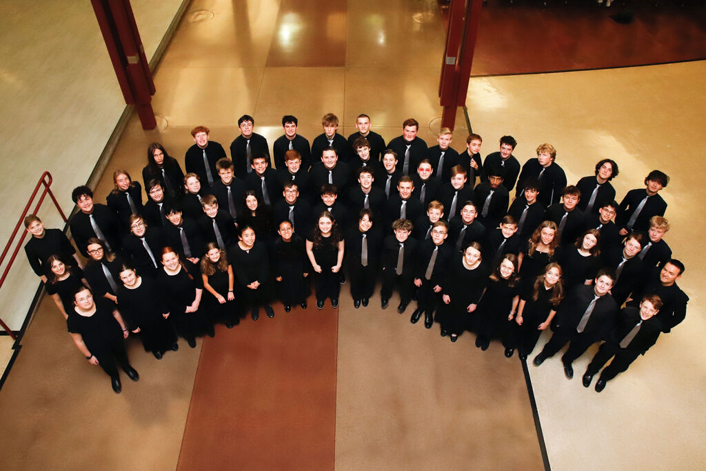Students dressed in black concert clothes on a lower floor